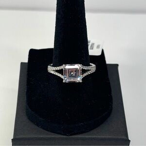 Rodium-plated sterling silver ring with square cut stone on a pave split band